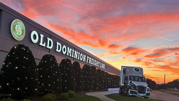 Truck in front of building with holiday lights